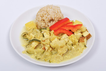 Cauliflower mixture with curry and rice on a white