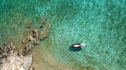 Aerial photo of jet ski docked in tropical turquoise clear water seascape