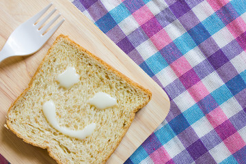 Smiles made from sweetened condensed milk on sliced bread.