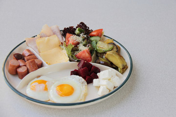 eggs with sausages and cheese and vegetables for breakfast