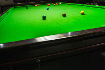Snooker table with Multicolor snooker balls on green in the club