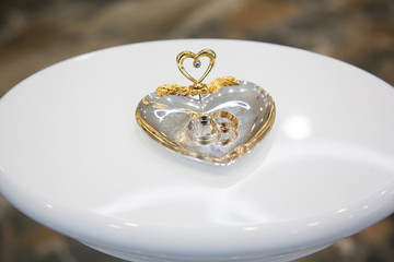 Gold wedding rings on the stand for rings