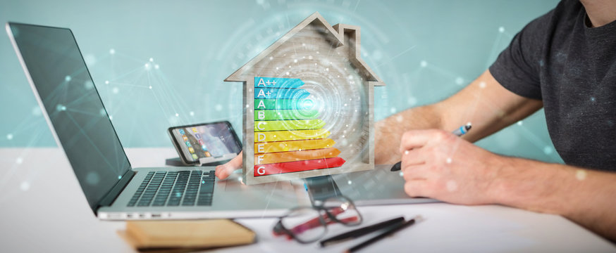 Graphic designer using 3D rendering energy rating chart in a wooden house