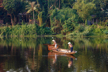 Fototapeta na wymiar Vietnamese fishermen in famous Perfume River in Hue City, Vietnam