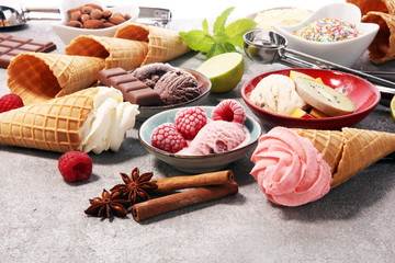 Vanilla frozen yogurt or soft ice cream and waffle cone and fruits.