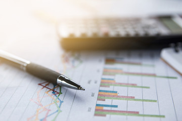 Financial analyzing concept, Pen and calculator on paperwork