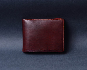 Brown leather wallet on gray texture