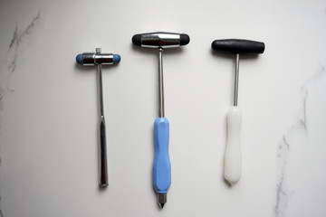 different reflex hammers on a marble background