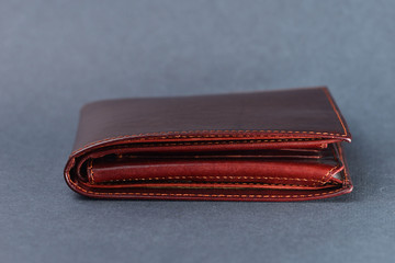 Brown leather wallet on gray texture