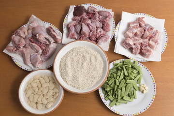 dishes with raw ingredients of chicken and rabbit paella