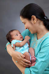 Mother holding newborn baby - 205913224
