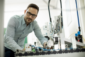 Young man in the electronic workshop