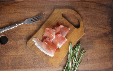 prosciutto, jamon on a wooden background