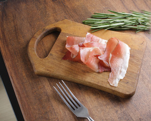prosciutto, jamon on a wooden background