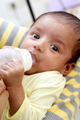 Baby boy drinking milk from bottle