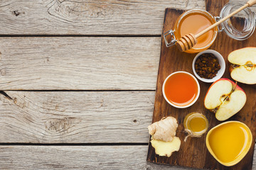 Various types of honey on wooden background, top view