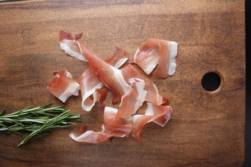 prosciutto, jamon on a wooden background