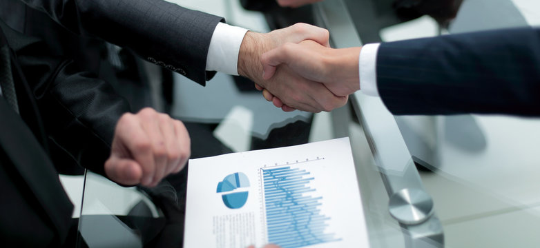 close up. investor and businessman shaking hands