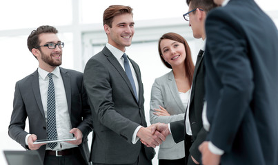 colleagues shaking hands in office