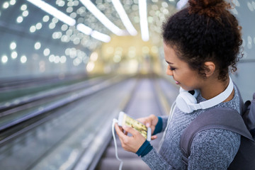 Young woman on subway escalator
