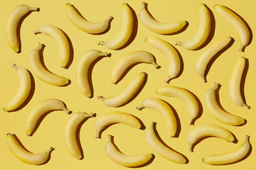 Ripe bananas on yellow background, Banana pattern flat lay