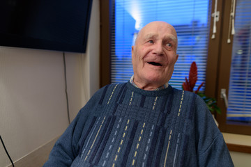 Senior man relaxing at nursing home in Turku, Finland