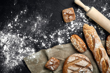 Mixed breads on black table. Top view with copy space.