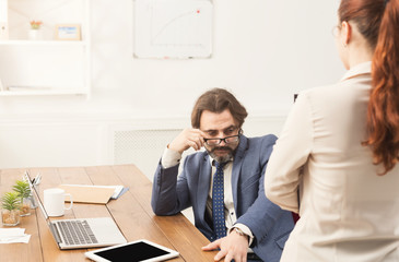 Sexual harassment at work, back view