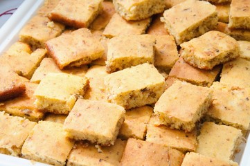 Stacked slices of homemade cornbread. freshly baked,  cut into squares close up top view 