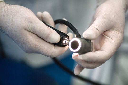 proctologist holding anoscope