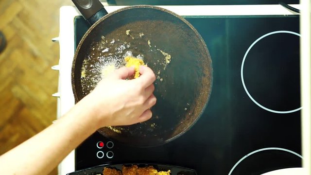 Fry nagets in a frying pan. Dipping into boiling oil.