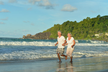 Happy elderly couple running