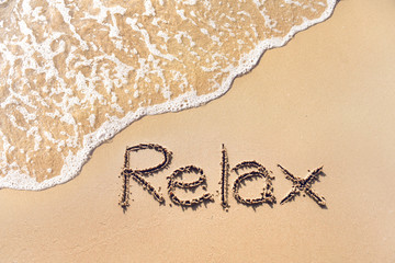 Relax on sand beach with wave in summer.