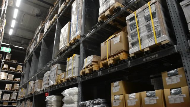 Camera travels inside a large store. Warehouse shipping.