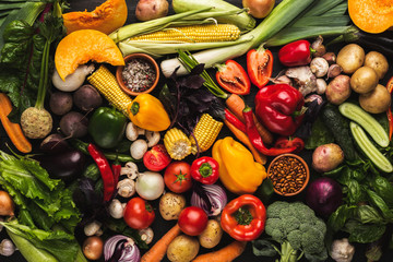 Heap of fresh vegetables on wooden background with copy space