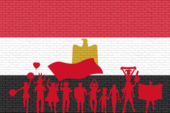 Egyptian supporter silhouette in front of brick wall with Egypt flag