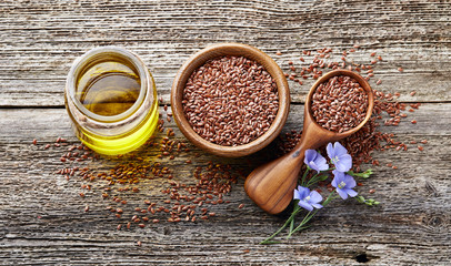 Flax oil on wooden background