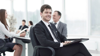 business man at office with his business team working behind
