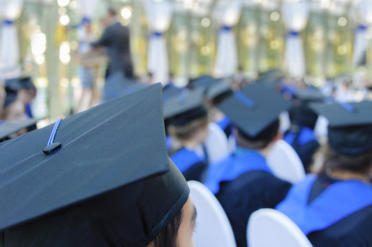 Students wearing gowns at school graduation cermoney