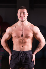 Fototapeta na wymiar Portrait of muscular mixed race man in gym