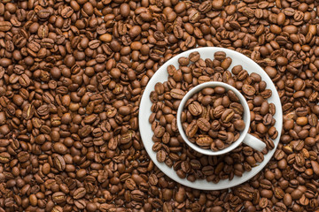 The coffee cup and saucer are filled with coffee grains