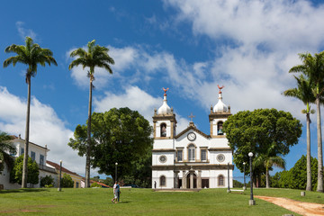 View of square with palm trees and church in the historic city of Vassouras, Rio de Janeiro on sunny day.