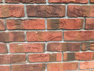 Surface of a red brick wall on a sunny day 