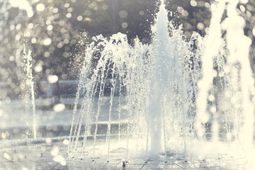 Spurting water from a fountain. Shallow depth of field.