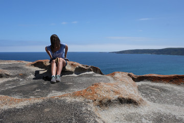 photo of girl with cell phone on the ocean