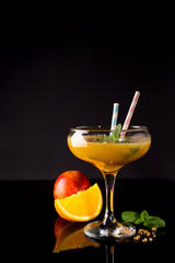 Frozen cocktail smoothie Margarita on a black glass background,