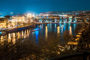Beautiful night city with lights, river and bridges. View from above. Top view. Prague, Czech Republic