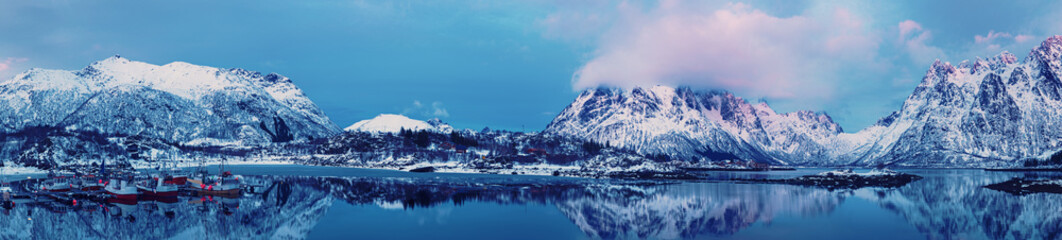 Obraz na płótnie Canvas Landscape with beautiful winter lake and snowy mountains at Lofoten Islands in Northern Norway. Panoramic view