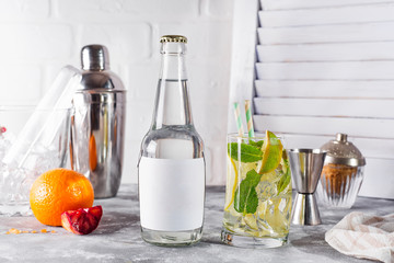 Mojito classic cocktail with lime and mint in a glass on white wooden background ,