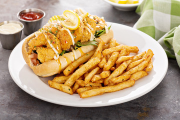 Shrimp po boy sandwich with fries